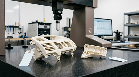 CNC machined ABS prototypes for automotive interior trim inspected in a metrology lab