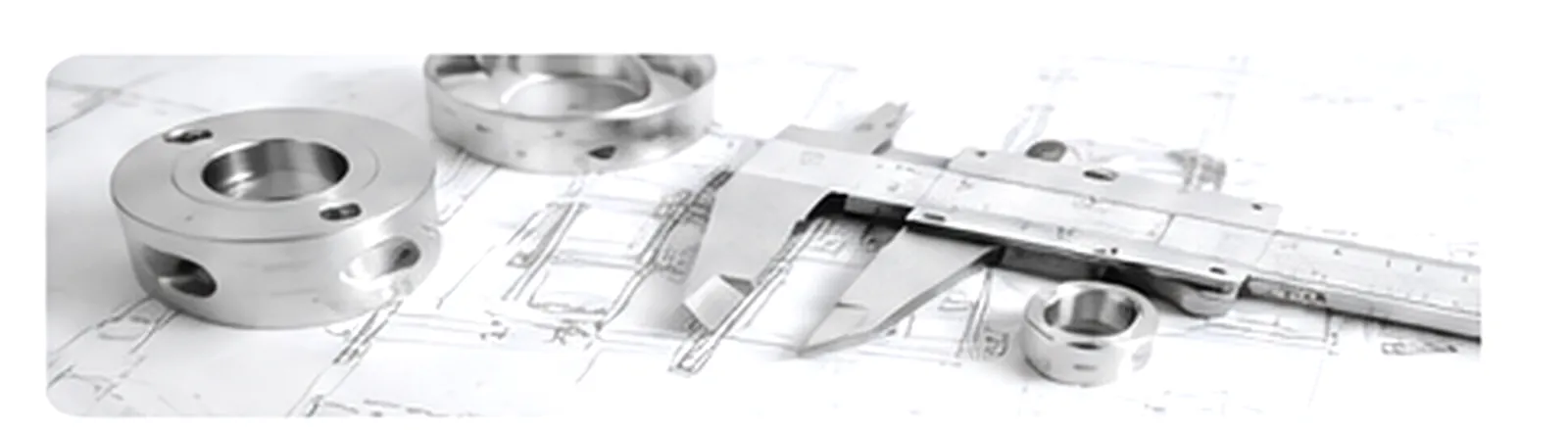 Engineering drawing, machined components, caliper, and measurement tools used during technical review